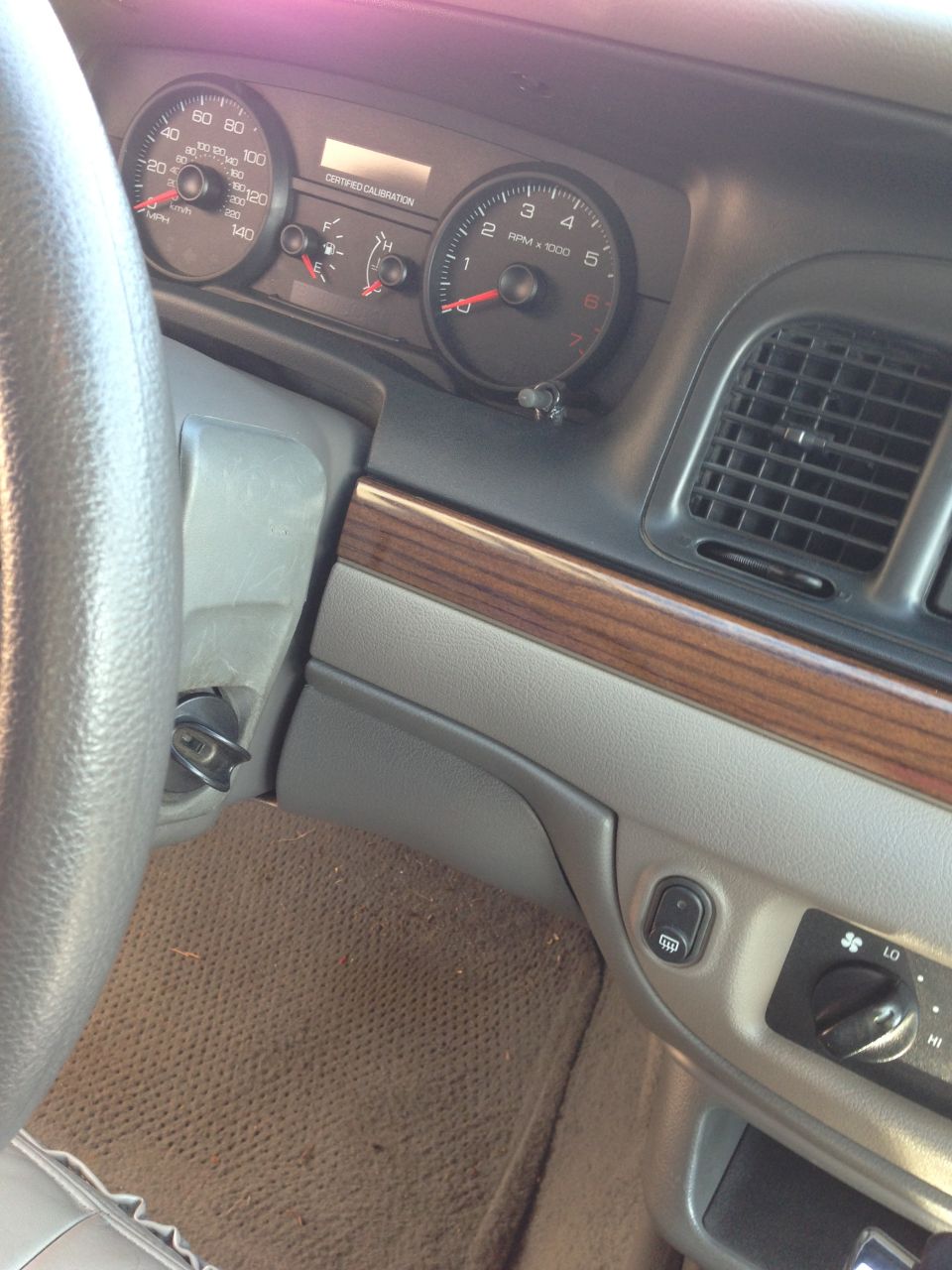 2007 Ford Crown Victoria interior dashboard with speedometer and tachometer visible