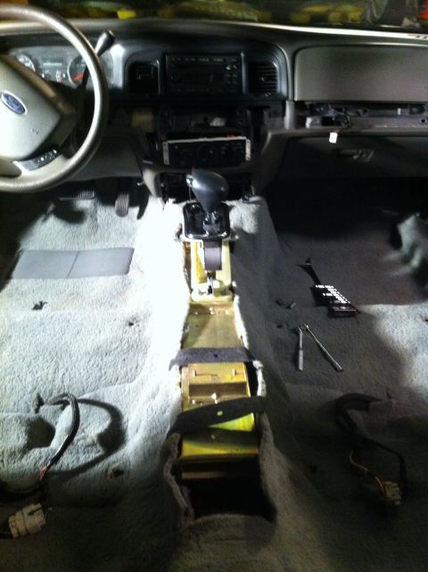 2007 Ford Crown Victoria - Interior of a 2007 Ford Crown Victoria with the center console and carpet removed for modification.