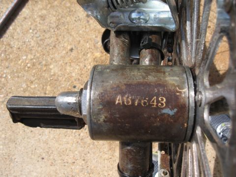Rusty bicycle crankset with serial number A67643 stamped on the side