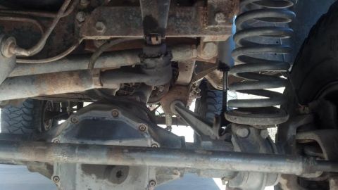 1991 Ford Bronco - Close-up of the suspension and drivetrain components of an off-road vehicle.