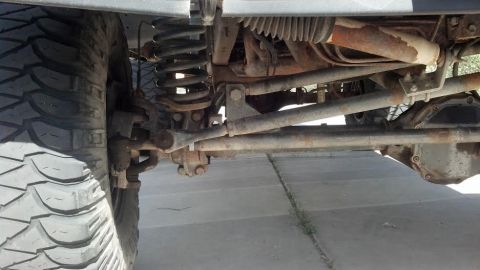 1991 Ford Bronco - Close-up view of the suspension and drivetrain components of an off-road vehicle.