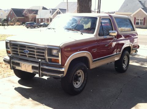 1986 Ford Bronco - This Ford Bronco is parked in front of a suburban house on a sunny day.