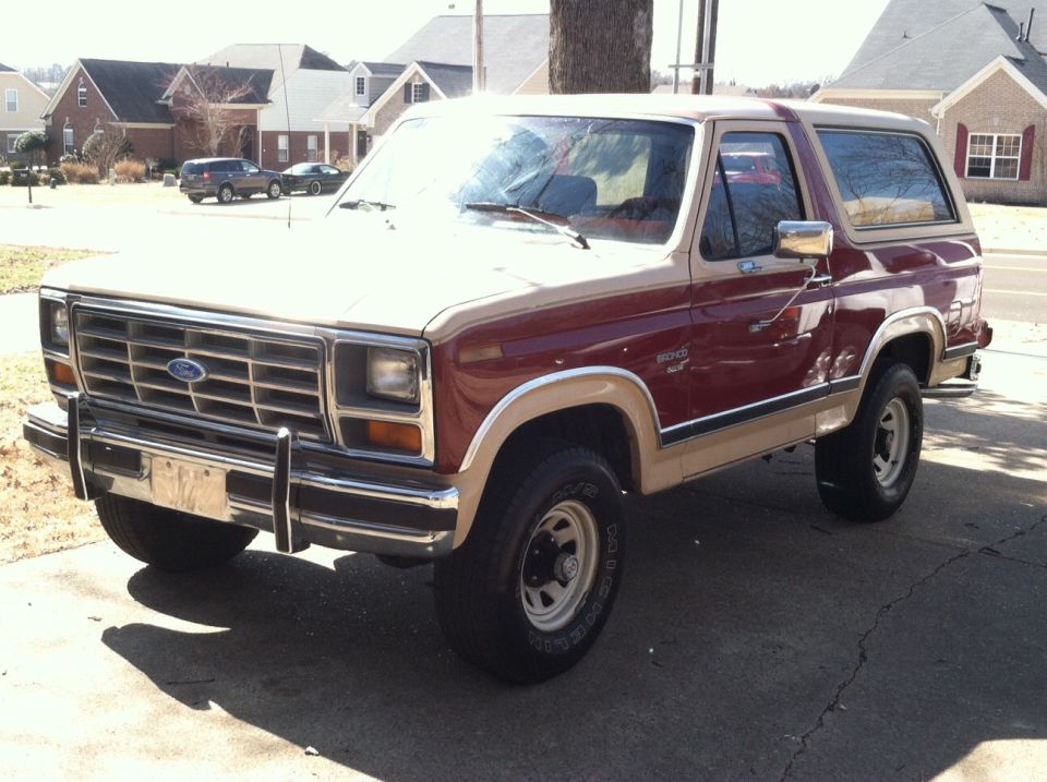 Two-tone red and tan Ford Bronco parked on a driveway