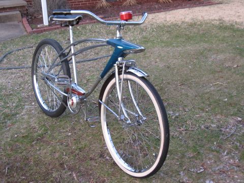 1994 Ford Bronco - This vintage bicycle features a distinctive blue front fairing and chrome accents, with whitewall tires and a red taillight.