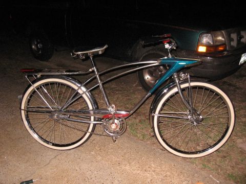 1994 Ford Bronco - A vintage bicycle with chrome detailing and white-wall tires is parked outdoors.