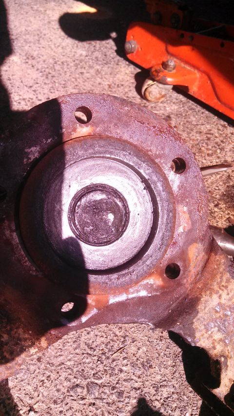 1979 Ford Bronco - A heavily rusted wheel hub assembly is shown, with a black seal visible in the center.