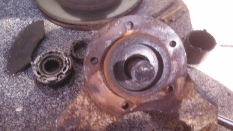1979 Ford Bronco - A close-up view of a rusty brake rotor, hub assembly, and brake pad, with a Supermotors.net logo visible.