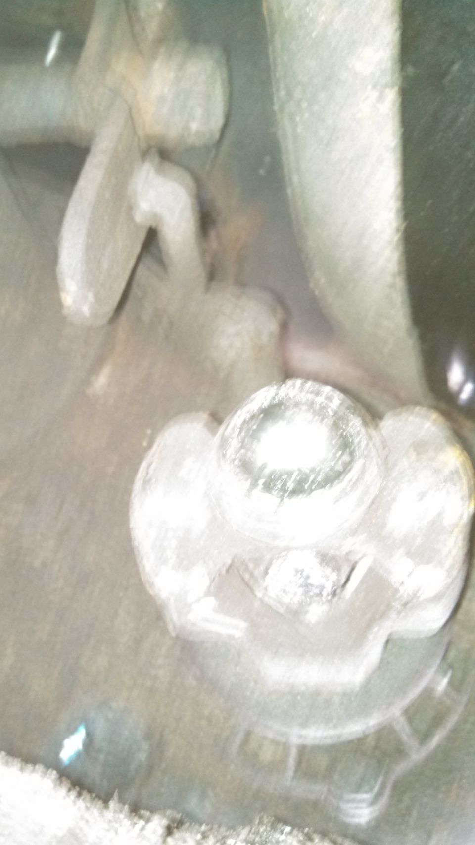 Close-up of a vehicle's wheel hub assembly with lug nuts visible