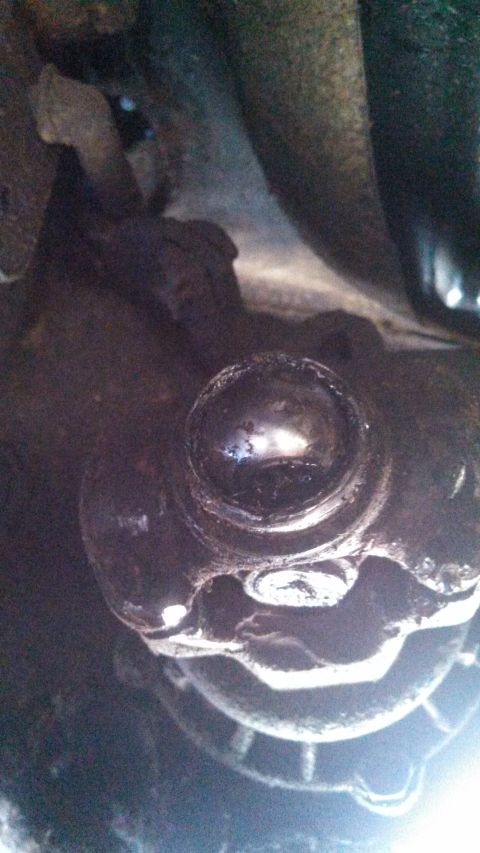 1979 Ford Bronco - A close-up view of a greasy driveshaft universal joint, likely from underneath a vehicle.