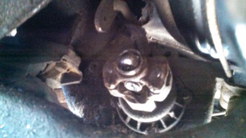 1979 Ford Bronco - Underside view of a vehicle's driveshaft universal joint, showing mechanical components.