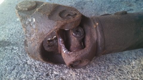 1979 Ford Bronco - Close-up of a worn driveshaft universal joint, likely needing replacement.