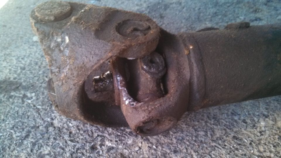 Driveshaft universal joint with visible wear and rust