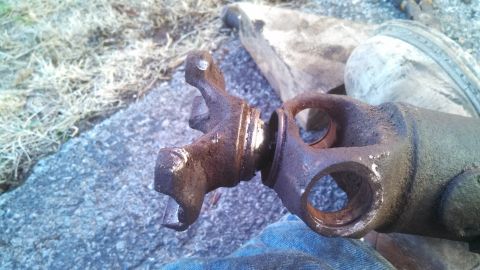 1979 Ford Bronco - A close-up view of a corroded driveshaft component, indicating it is a vehicle part.