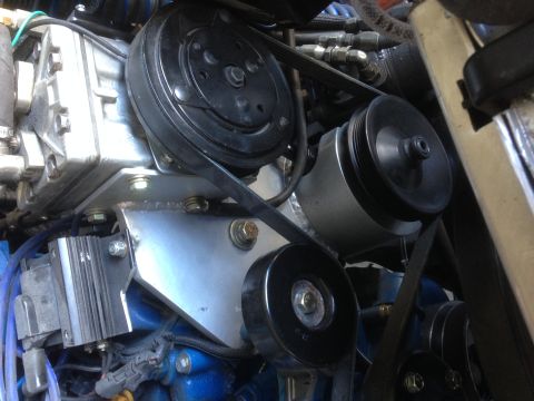 1971 Ford Bronco - Close-up of engine components including AC compressor, pulleys, and serpentine belt system.