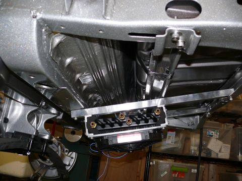 Undercarriage of a vehicle showing a custom exhaust system and fan assembly