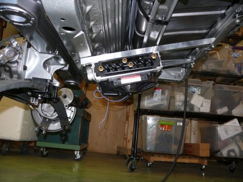 Underside of a car showing suspension components and fuel lines. The page claims it's a 1976 Chevrolet Corvett