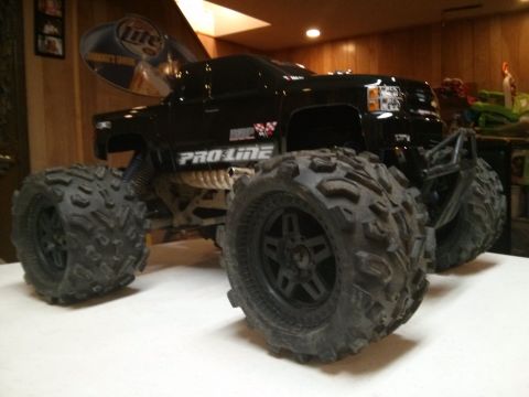 1986 Ford Bronco - This black remote control monster truck features oversized tires and "PRO-LINE" branding on its side.