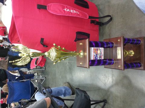 2003 Mercury Marauder - A trophy is displayed in front of a large red bag, with people seated in the background.
