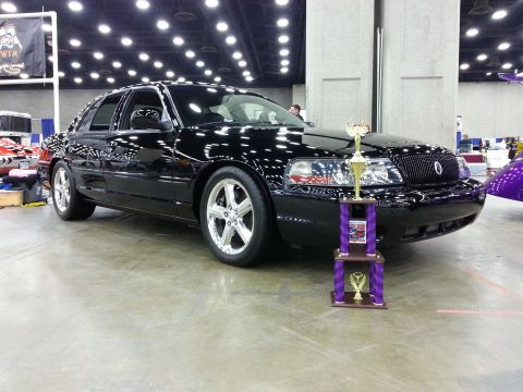 2003 Mercury Marauder - A black 2003 Mercury Marauder is displayed with trophies at a car show.