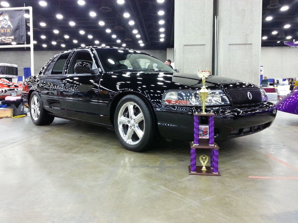 Black 2003 Mercury Marauder with chrome wheels and a trophy in front