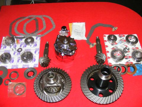 1978 Ford Bronco - A collection of differential gears, bearings, and gaskets is laid out on a red surface.