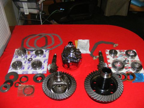 1978 Ford Bronco - Various automotive differential components are displayed on a red cloth, ready for installation or repair.