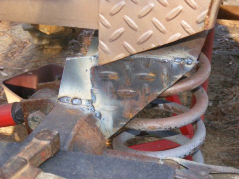 1978 Ford Bronco - Close-up view of modified suspension components with visible welds and rust.