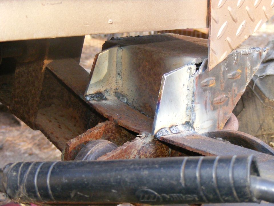 Welded metal frame components with diamond plate texture visible