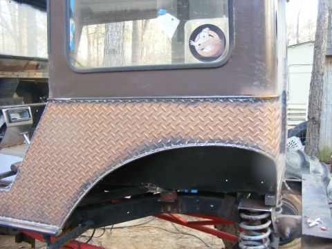 Diamond plate fender flare on a modified SUV rear quarter panel
