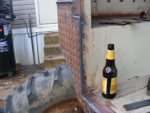 Diamond plate panel and large tire on a vehicle part