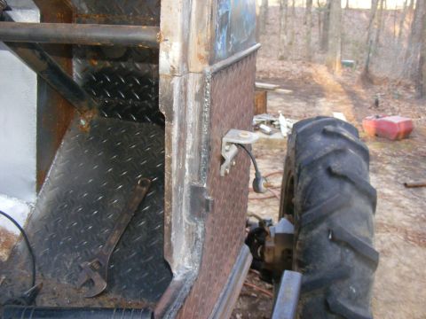 Modified vehicle side with diamond plate, large tractor tire, and wrench