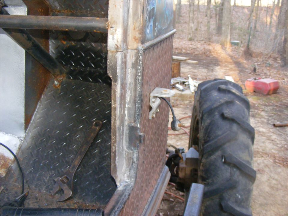 Modified vehicle side with diamond plate, large tractor tire, and wrench