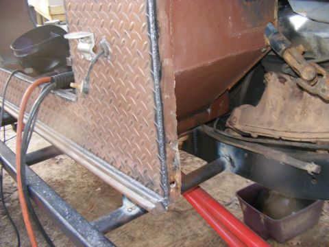 Diamond plate toolbox attached to trailer frame with welding equipment