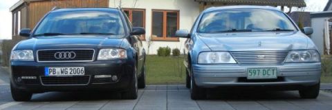 1999 Ford Fairlane - Two cars, an Audi and a silver sedan, are parked in a driveway.