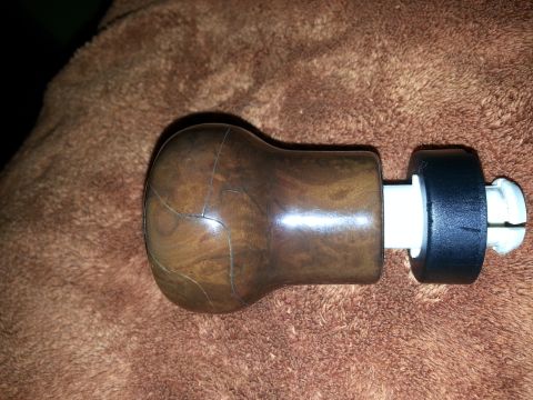 2002 Volkswagen Jetta - A wooden shift knob with visible cracks and plastic mounting hardware is shown against a brown fuzzy background.