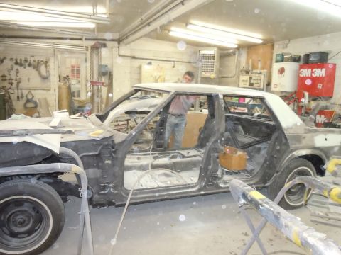 2001 Ford Crown Victoria - Car body in repair shop, doors removed, interior gutted, ready for bodywork.
