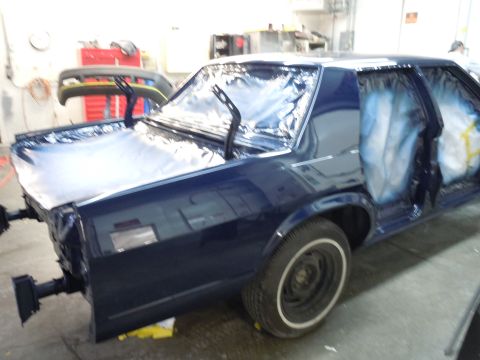 2001 Ford Crown Victoria - A 2001 Ford Crown Victoria is shown in a garage, with its windows taped off and doors open, ready for paintwork.