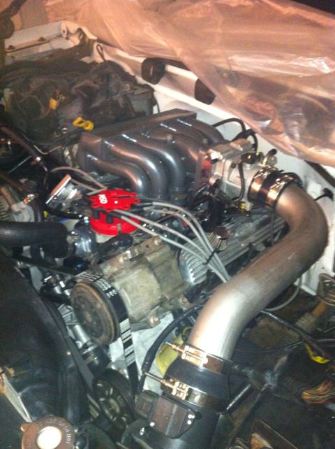 1992 Ford Bronco - The engine bay shows a Ford V8 with custom intake components and a red distributor cap.