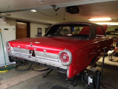 1964 Ford Fairlane - A red 1964 Ford Fairlane is shown in a garage, undergoing restoration.