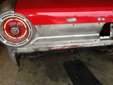 1964 Ford Fairlane - The rear section of a 1964 Ford Fairlane is shown, undergoing repairs with exposed metal and a red painted body.