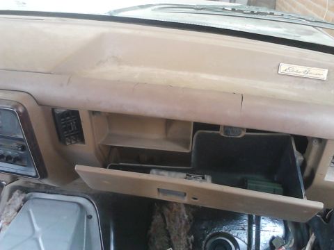 1990 Ford Bronco - Interior view of a 1990 Ford Bronco, highlighting the dashboard and glove compartment.