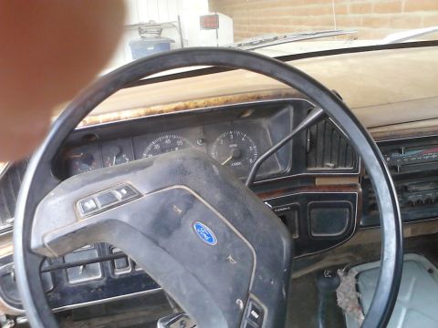 1990 Ford Bronco - The interior of a vintage Ford Bronco, showing the dashboard and steering wheel.