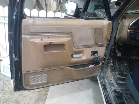 1990 Ford Bronco - Interior view of a 1990 Ford Bronco, showing the driver's side door panel and dashboard.