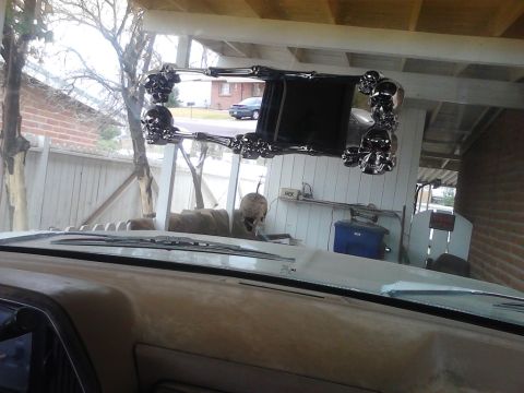 1990 Ford Bronco - The vehicle's interior features a unique rearview mirror adorned with chrome skulls and bone-like extensions.