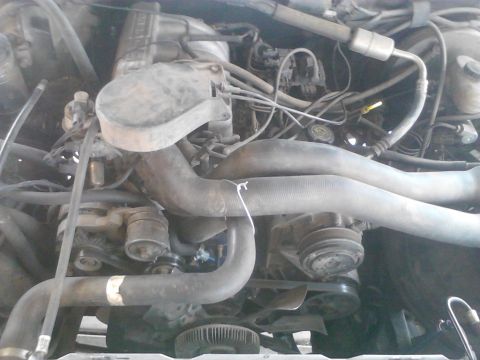 1990 Ford Bronco - Close-up view of an engine bay, showing various mechanical components and wiring.