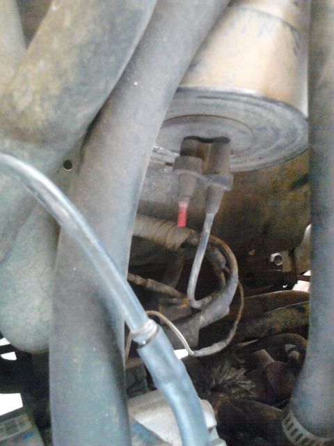 1990 Ford Bronco - This image shows various hoses and electrical connections within a vehicle's engine compartment.