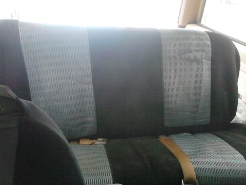 1990 Ford Bronco - back seat with seat covers on it