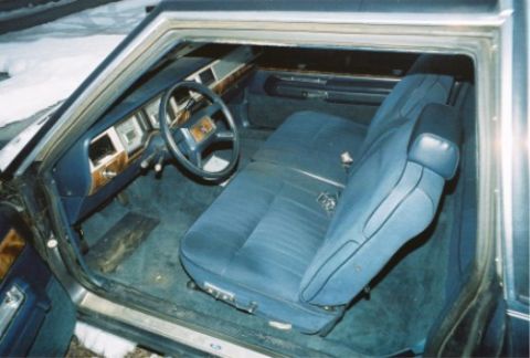 1984 Mercury Grand Marquis - The interior of a 1984 Mercury Grand Marquis shows blue cloth seats, wood grain trim, and the dashboard.