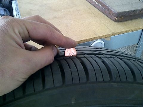 1993 Ford Probe - Tire tread depth is checked using a penny; the tread is deep enough to obscure Lincoln's head.