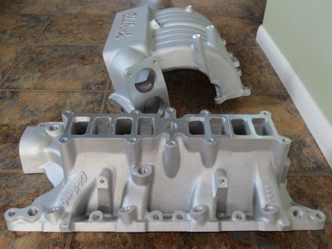 1996 Ford Bronco - Two Edelbrock intake manifolds are shown on a tiled floor.